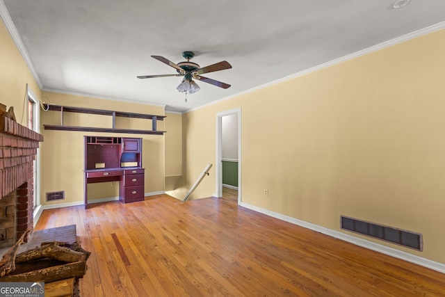 living area featuring a fireplace, visible vents, baseboards, ornamental molding, and hardwood / wood-style floors