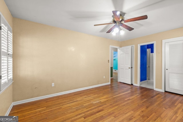 unfurnished bedroom featuring wood finished floors, a ceiling fan, and baseboards