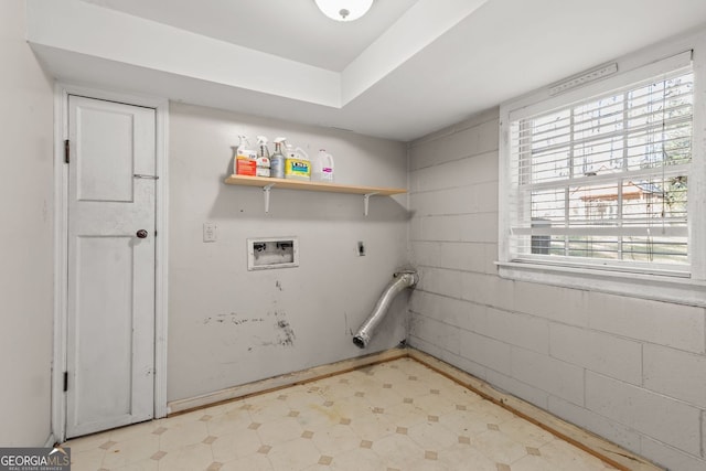 laundry room featuring concrete block wall, laundry area, light floors, washer hookup, and electric dryer hookup