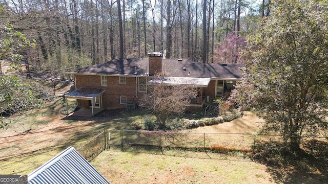 exterior space featuring a view of trees