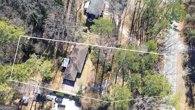 birds eye view of property featuring a view of trees