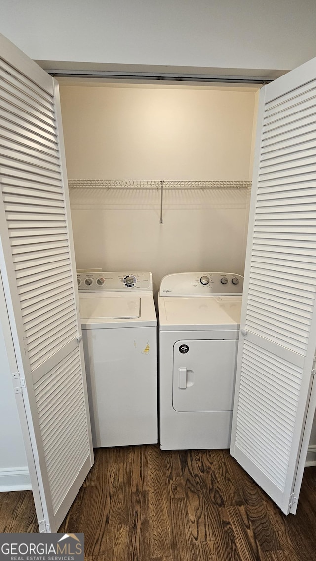 washroom featuring laundry area, dark wood-style flooring, and washer and dryer