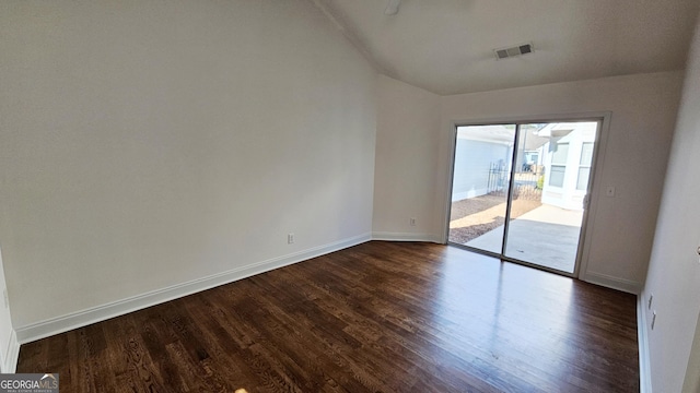 spare room featuring dark wood-style floors, baseboards, and visible vents