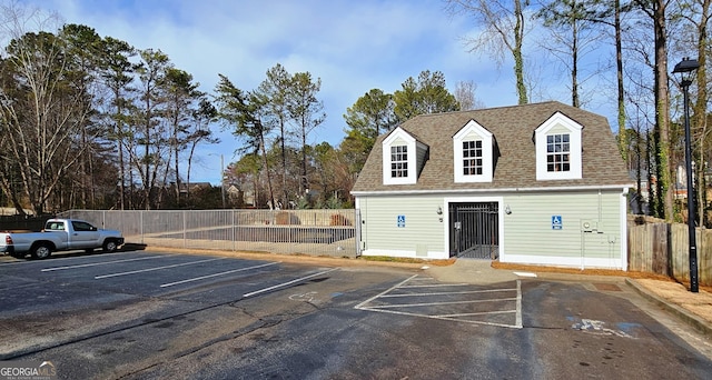 uncovered parking lot featuring fence