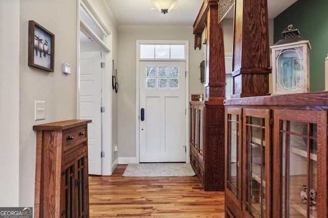 entryway featuring light wood-style flooring and baseboards