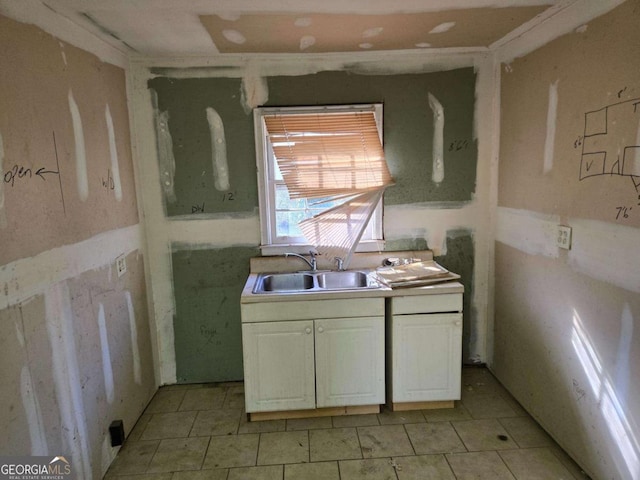 kitchen with a sink and white cabinetry