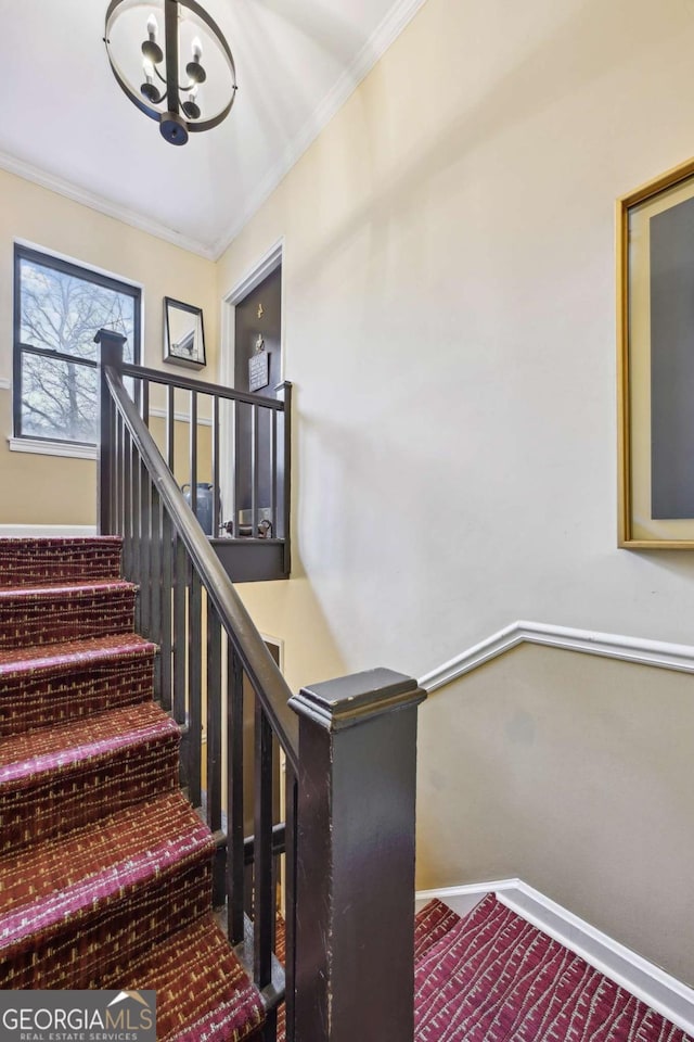 stairway with baseboards and ornamental molding