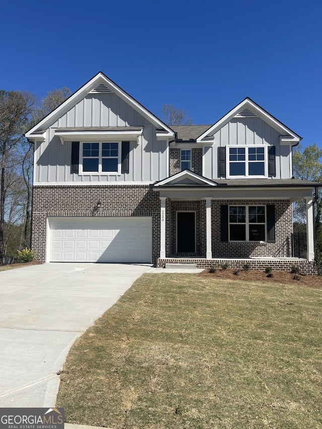 view of front of house with board and batten siding, covered porch, a garage, and concrete driveway