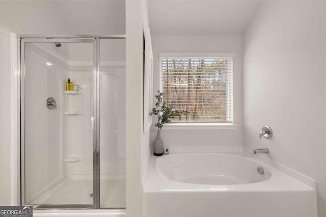 full bathroom with a garden tub and a shower stall