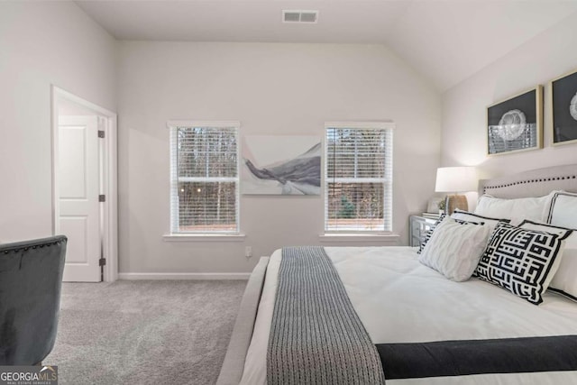 carpeted bedroom with lofted ceiling, baseboards, and visible vents