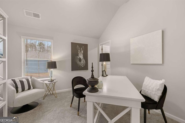 carpeted office space with lofted ceiling, visible vents, and baseboards