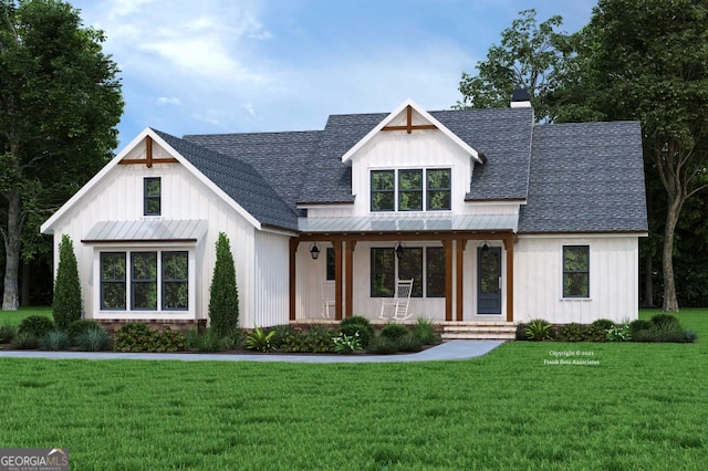 modern farmhouse style home featuring board and batten siding, a front yard, roof with shingles, and metal roof