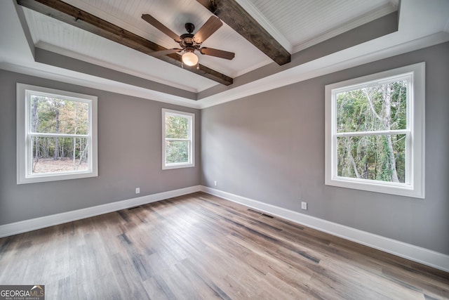 unfurnished room featuring beamed ceiling, a ceiling fan, baseboards, and wood finished floors