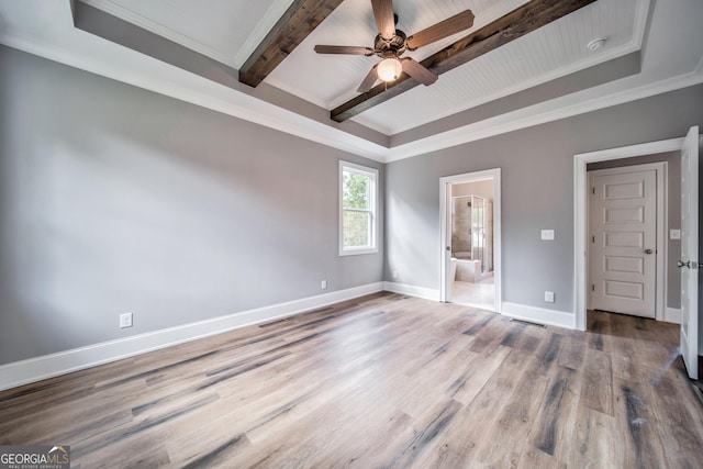 unfurnished bedroom featuring crown molding, baseboards, beamed ceiling, ensuite bathroom, and wood finished floors