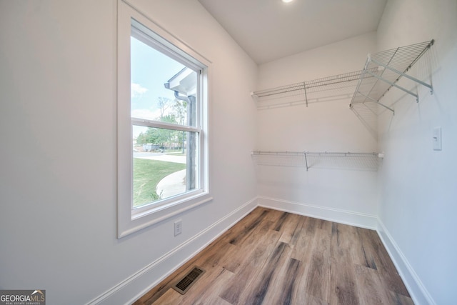 spacious closet featuring wood finished floors and visible vents