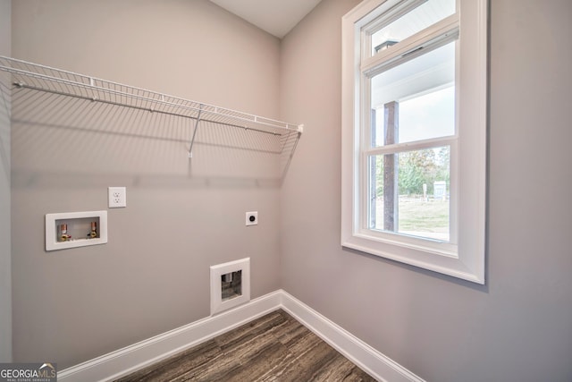 washroom with dark wood-style floors, baseboards, hookup for an electric dryer, hookup for a washing machine, and laundry area