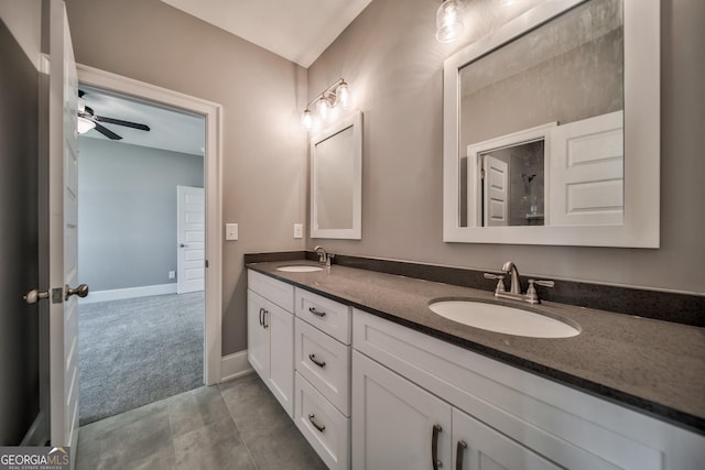 full bathroom featuring a sink, ceiling fan, double vanity, and tile patterned floors