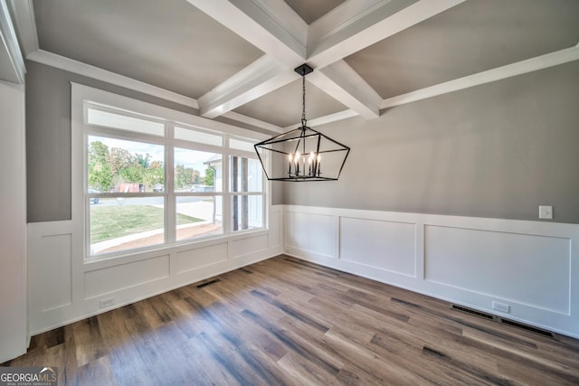 unfurnished dining area featuring wood finished floors, visible vents, coffered ceiling, beam ceiling, and a chandelier