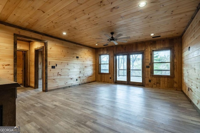 unfurnished room featuring wood ceiling, wood finished floors, french doors, wood walls, and recessed lighting