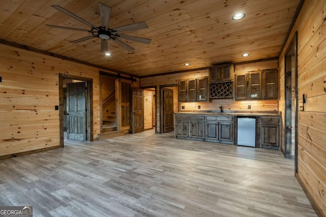 bar featuring a barn door, wooden walls, wooden ceiling, light wood-style flooring, and recessed lighting