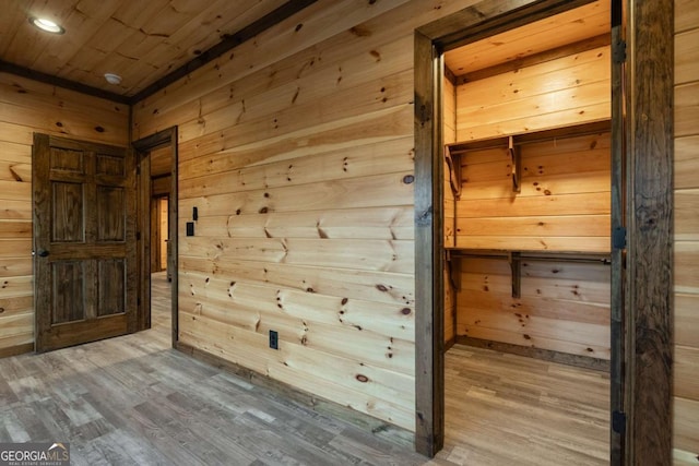 interior space featuring wood walls, wood ceiling, and wood finished floors