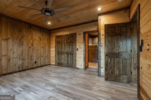 unfurnished bedroom featuring wooden ceiling, wood finished floors, and wood walls