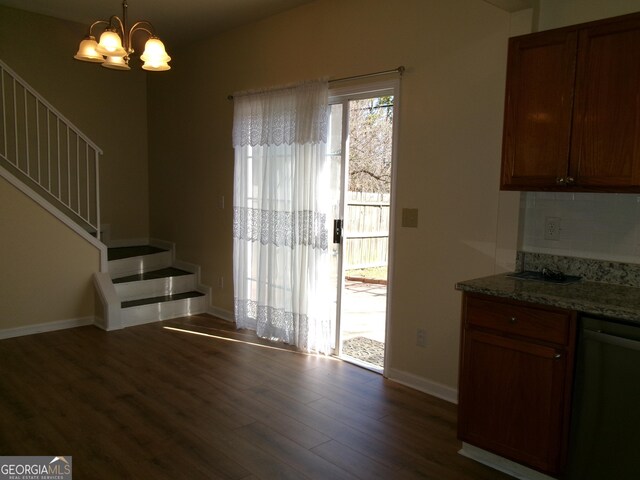 interior space featuring dark wood-style floors, stairway, a notable chandelier, and baseboards