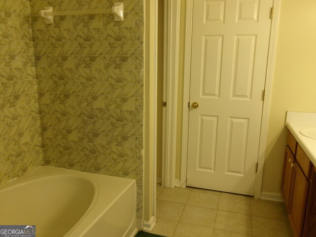 bathroom featuring a washtub, tile patterned flooring, and vanity