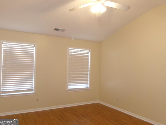 empty room featuring baseboards, visible vents, ceiling fan, and wood finished floors