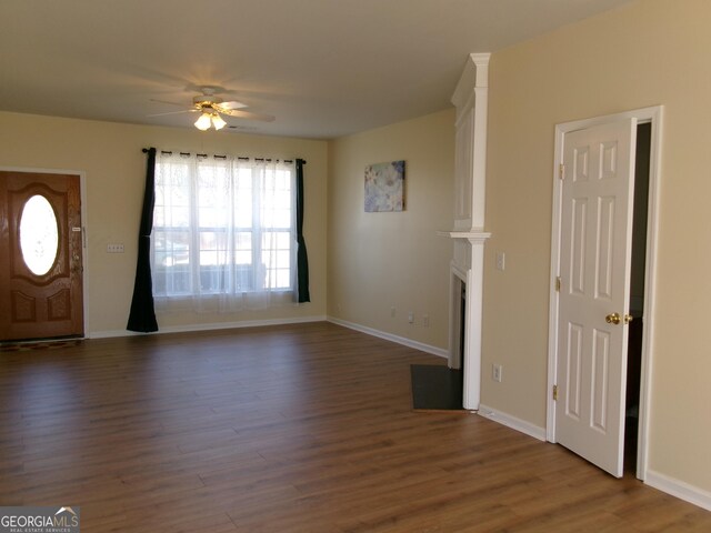 entryway featuring dark wood-type flooring, baseboards, and a ceiling fan