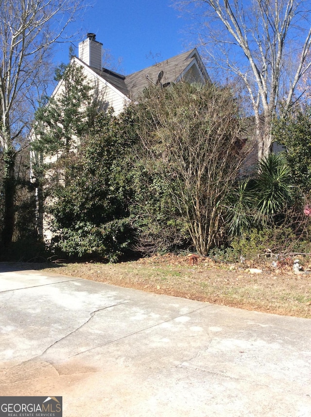 view of property exterior with a chimney