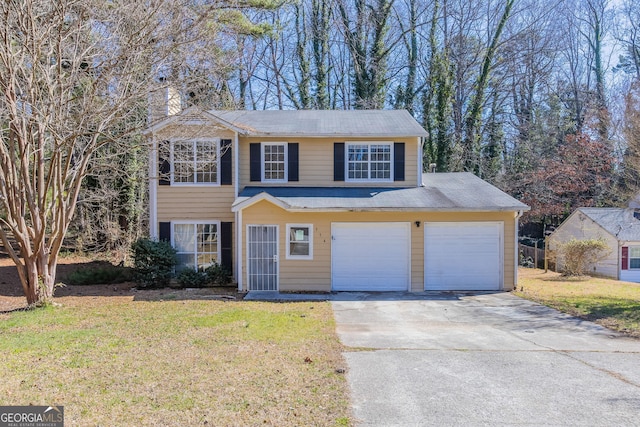 view of front of house with an attached garage, driveway, and a front lawn