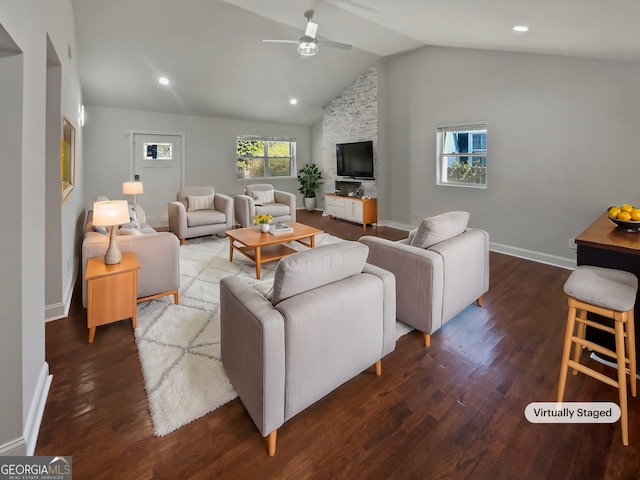 living room with baseboards, a ceiling fan, vaulted ceiling, and wood finished floors