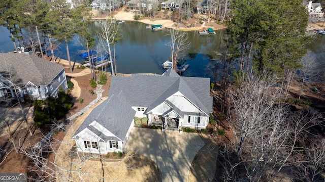 birds eye view of property with a water view