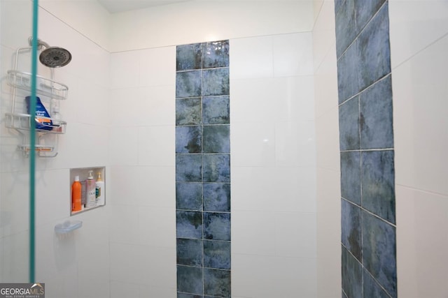 bathroom with a tile shower