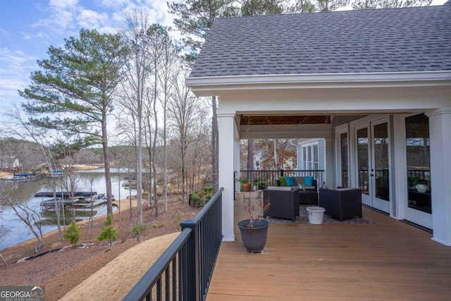 deck with french doors, a water view, and outdoor lounge area