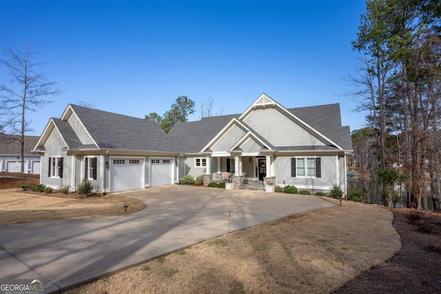 craftsman inspired home featuring a garage and driveway