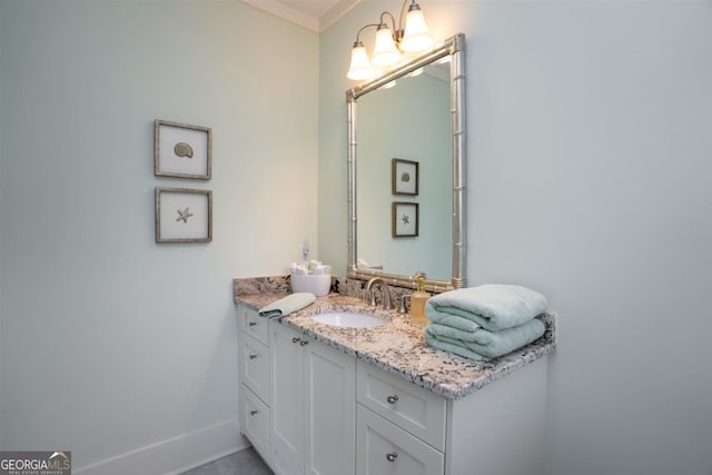 bathroom featuring ornamental molding, vanity, and baseboards