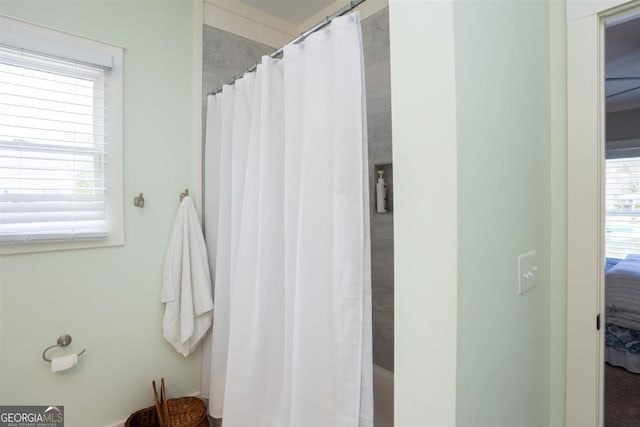 full bathroom featuring a shower with shower curtain and ensuite bath