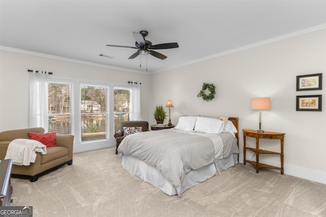 carpeted bedroom with ornamental molding, visible vents, baseboards, and a ceiling fan