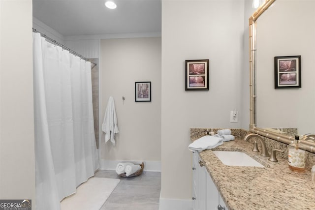 bathroom featuring vanity and baseboards