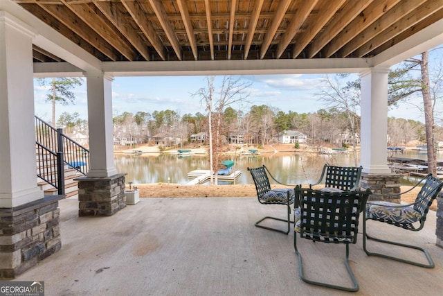 view of patio / terrace with a boat dock and a water view