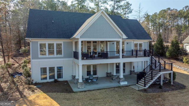 rear view of house featuring a balcony, a shingled roof, french doors, stairway, and a patio area