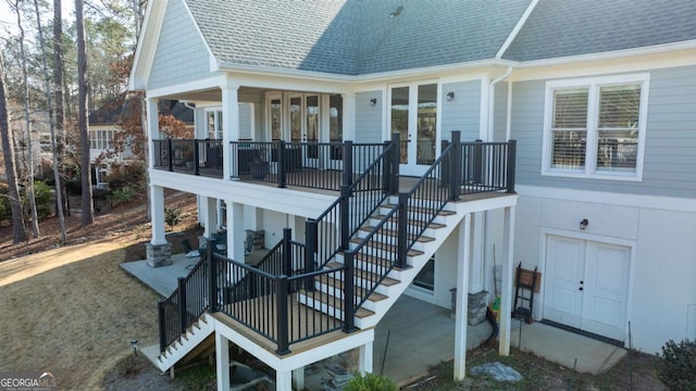 wooden deck featuring stairway, a patio, and french doors