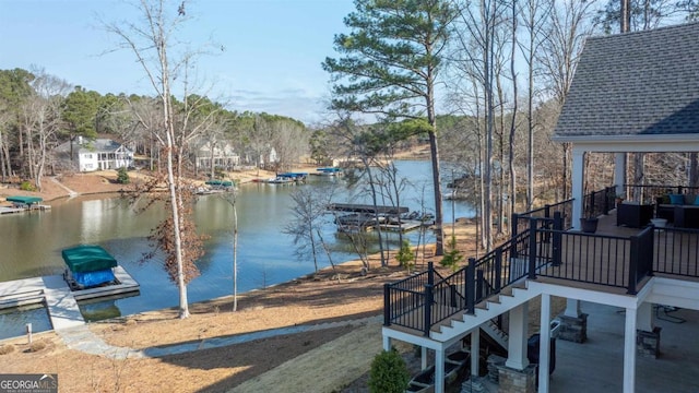 view of dock featuring stairs and a water view