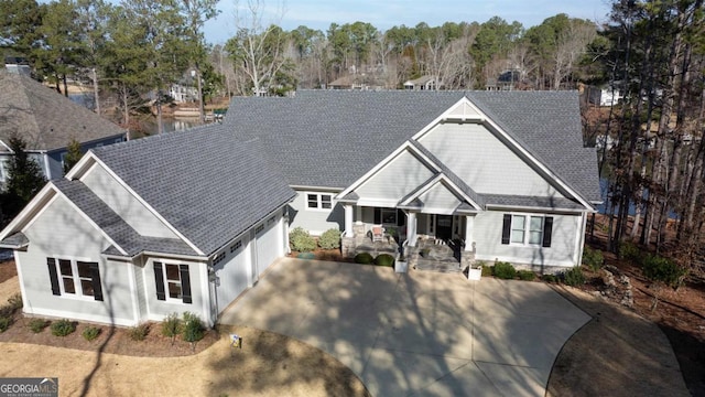 view of front of property featuring a porch and a shingled roof