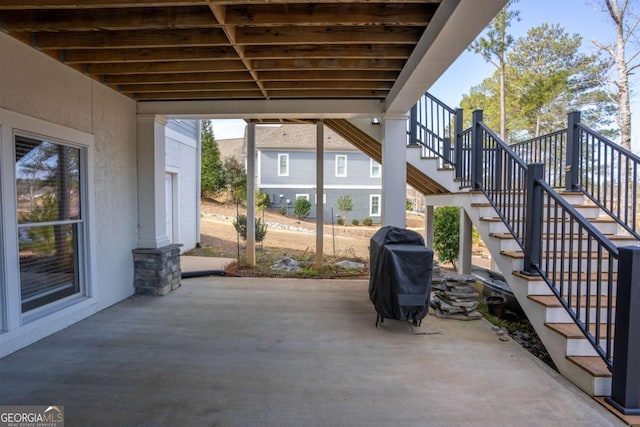 view of patio featuring a grill and stairs