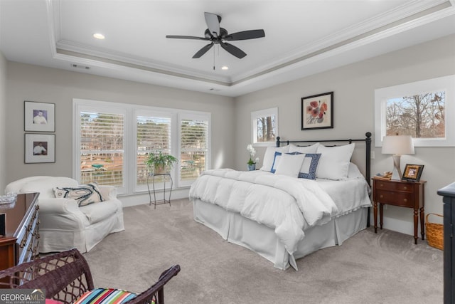 bedroom with light carpet, ornamental molding, a raised ceiling, and recessed lighting