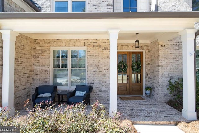 entrance to property with brick siding and french doors