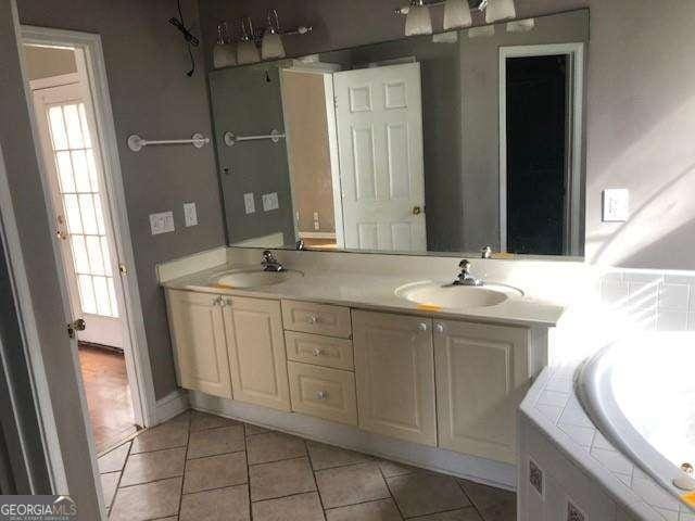 bathroom featuring double vanity, tile patterned flooring, and a sink